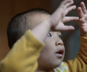 Image of a child holding their hands up in the air
